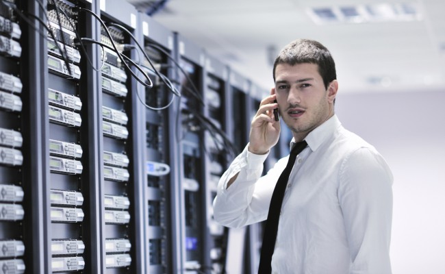 It engeneer talking by phone at network room